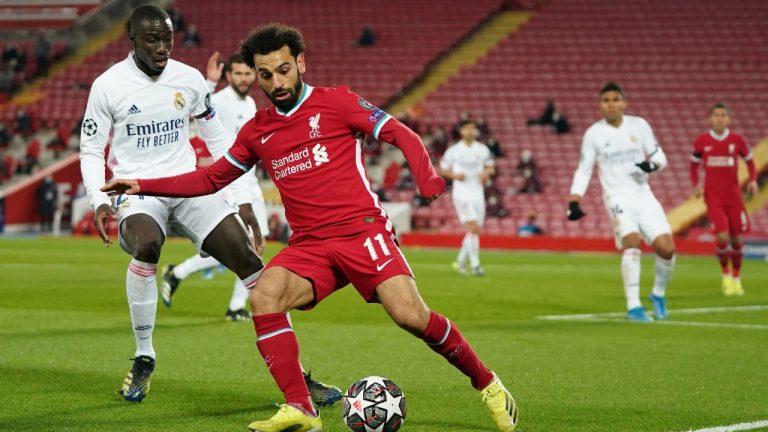 Liverpool's Mohamed Salah, is challenged by Real Madrid's Ferland Mendy. (Jon Super/AP)