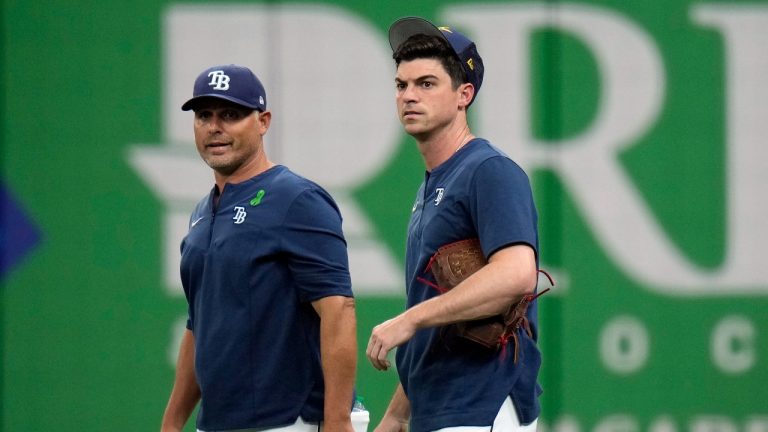 Tampa Bay Rays relief pitcher Brooks Raley, right, a native of Uvalde, Texas, talks to manager Kevin Cash before a baseball game against the New York Yankees, Thursday, May 26, 2022, in St. Petersburg, Fla. (Chris O'Meara/AP Photo)