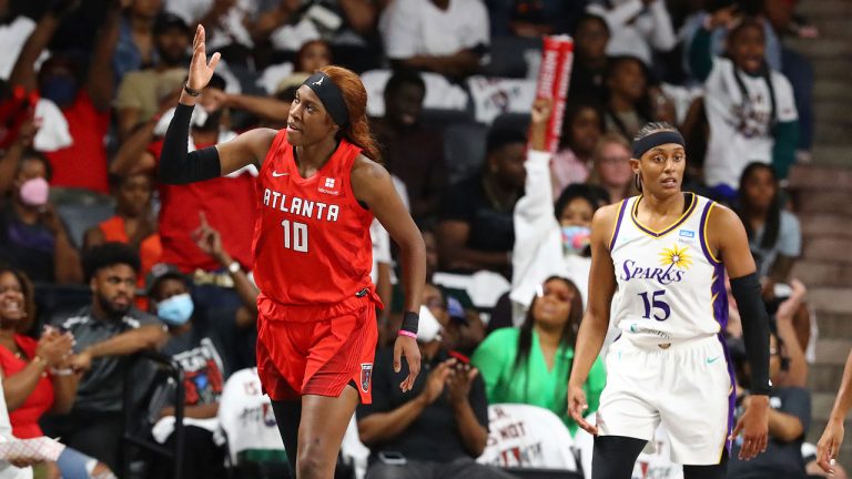 Atlanta Dream guard Rhyne Howard reacts to hitting a three pointer against Los Angeles Sparks guard Brittney Sykes during during a WNBA basketball game. (Curtis Compton/AP