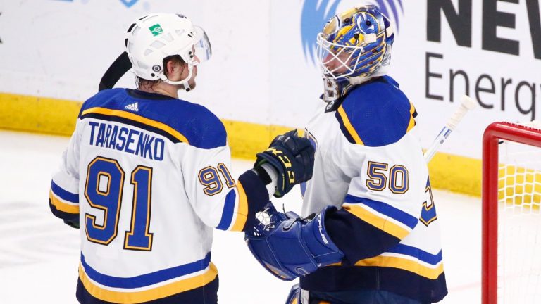 St. Louis Blues right wing Vladimir Tarasenko (91) and goaltender Jordan Binnington (50) celebrate a victory after the third period of an NHL hockey game against the Buffalo Sabres, Thursday, April 14, 2022, in Buffalo, N.Y. (Jeffrey T. Barnes/AP)