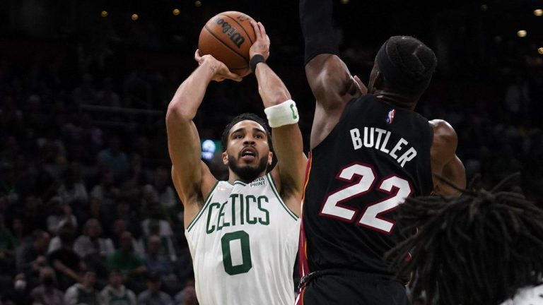 Boston Celtics forward Jayson Tatum (0) shoots over Miami Heat forward Jimmy Butler (22) during the second half of Game 4 of the NBA basketball playoffs Eastern Conference finals, Monday, May 23, 2022, in Boston. (Charles Krupa/AP)