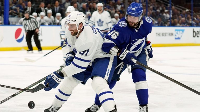 Toronto Maple Leafs center John Tavares (91) and Tampa Bay Lightning right wing Nikita Kucherov (86) battle for the puck during the third period in Game 4 of an NHL hockey first-round playoff series Sunday, May 8, 2022, in Tampa, Fla. (Chris O'Meara/AP)