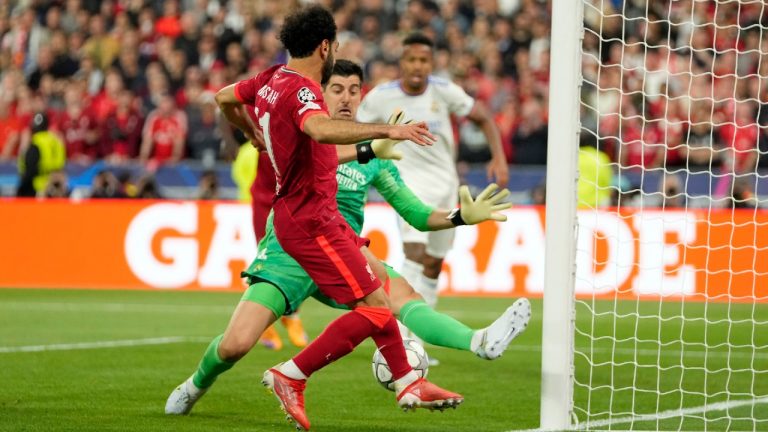 Real Madrid's goalkeeper Thibaut Courtois makes a save in front of Liverpool's Mohamed Salah, left, during the Champions League final soccer match between Liverpool and Real Madrid at the Stade de France in Saint Denis near Paris, Saturday, May 28, 2022. (Manu Fernandez/AP)