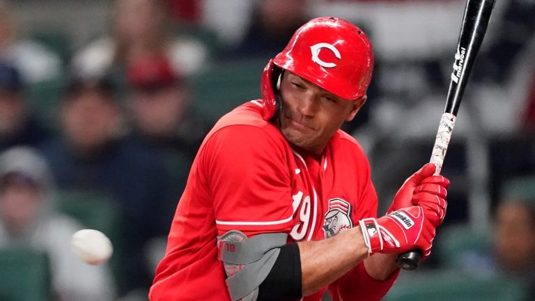 Cincinnati Reds' Joey Votto (19) is hit by a pitch in the fifth inning of a baseball game against the Atlanta Braves Friday, April 8, 2022, in Atlanta. Votto entered play this weekend hitting below .125. (John Bazemore/AP Photo)