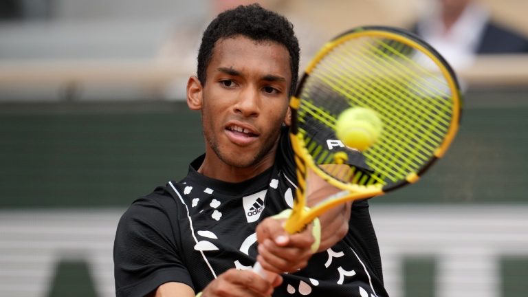 Canada's Felix Auger-Aliassime plays a shot against Peru's Juan Pablo Varillas during their first round match at the French Open tennis tournament in Roland Garros stadium in Paris, France, Sunday, May 22, 2022. (Christophe Ena/AP)