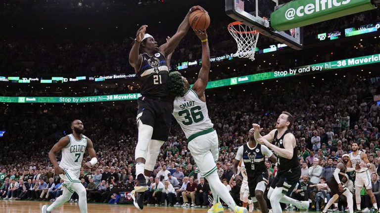 Milwaukee Bucks guard Jrue Holiday (21) blocks a shot by Boston Celtics guard Marcus Smart (36) in the final seconds of play during the second half of Game 5 of an Eastern Conference semifinal in the NBA basketball playoffs. (Charles Krupa/AP)