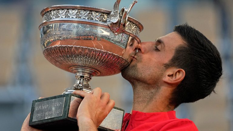 Serbia's Novak Djokovic kisses the cup after defeating Stefanos Tsitsipas of Greece in their final match of the French Open tennis tournament at the Roland Garros stadium Sunday, June 13, 2021 in Paris (Michel Euler/AP)