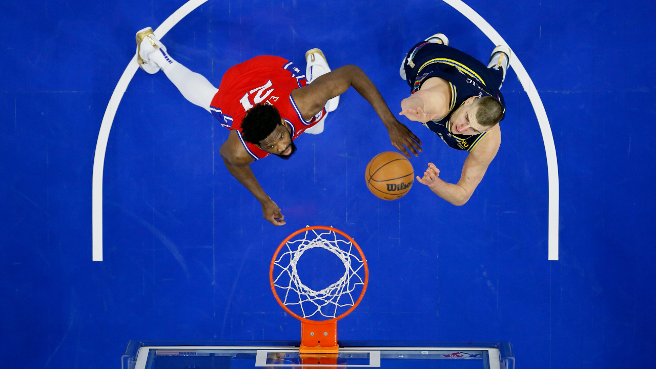 Denver Nuggets' Nikola Jokic, right, goes up for a shot against Philadelphia 76ers' Joel Embiid during the second half of an NBA basketball game, Monday, March 14, 2022, in Philadelphia. (Matt Slocum/AP) 