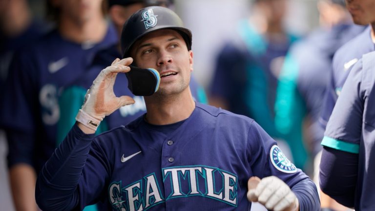 Seattle Mariners' Adam Frazier reacts in the dugout after he scored a run on an RBI-single hit by Julio Rodriguez during the third inning of a baseball game against the Philadelphia Phillies, Wednesday, May 11, 2022, in Seattle. (Ted S. Warren/AP)