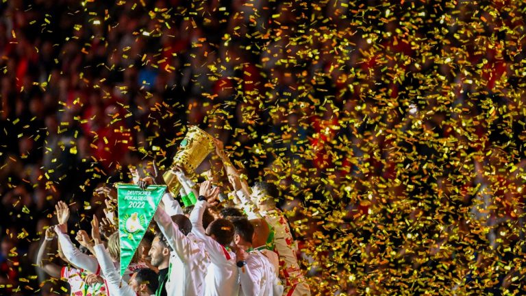 Leipzig players celebrate with the German Soccer Cup trophy after the final match between RB Leipzig against SC Freiburg at the Olympic Stadium in Berlin, Germany, Saturday, May 21, 2022. (Robert Michael/AP)