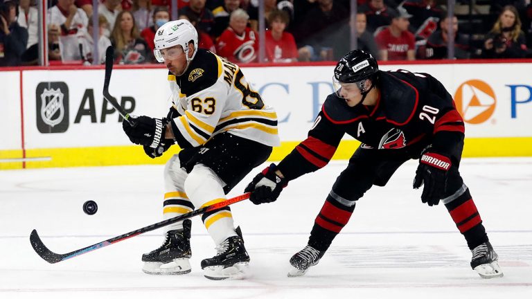 Boston Bruins' Brad Marchand (63) competes for the puck against Carolina Hurricanes' Sebastian Aho (20) during the first period of Game 2 of an NHL hockey Stanley Cup first-round playoff series. (Karl B DeBlaker/AP)