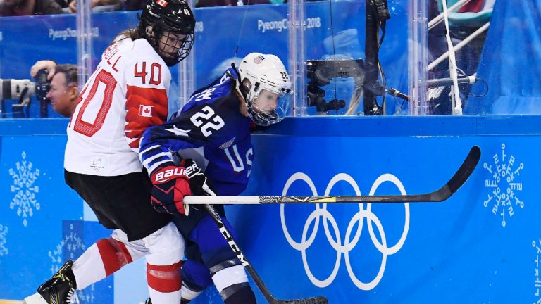 Canada forward Blayre Turnbull (40) and United States defenceman Kacey Bellamy (22) battle for the puck during first period women's gold medal final Olympic hockey action at the 2018 Olympic Winter Games in Gangneung, South Korea on Thursday, February 22, 2018. (Nathan Denette/CP)