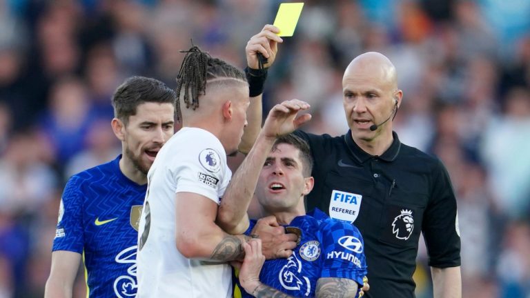 Leeds United's Kalvin Phillips, left, receives a yellow card as he holds Chelsea's Christian Pulisic during their English Premier League soccer match at Elland Road in Leeds, England on Wednesday. (Jon Super/AP)