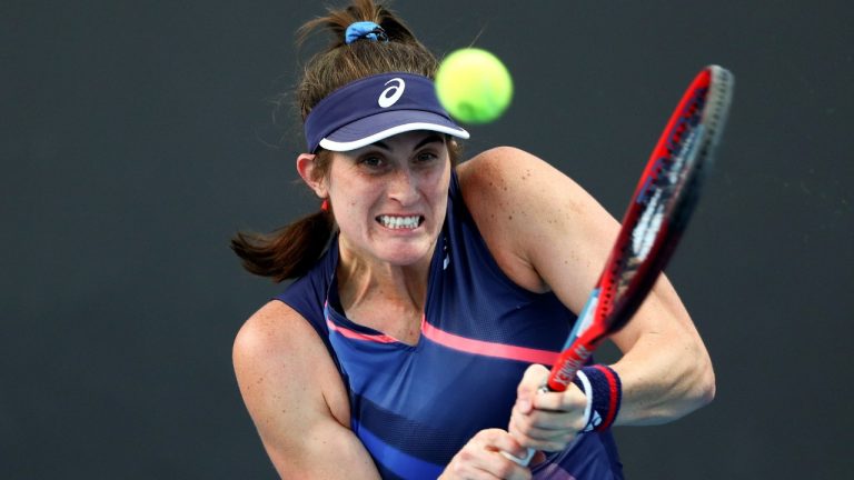 Rebecca Marino of Canada plays a backhand return to Marie Bouzkova of the Czech Republic during their first round match at the Australian Open tennis championships in Melbourne, Australia, Tuesday, Jan. 18, 2022. (Tertius Pickard/AP)