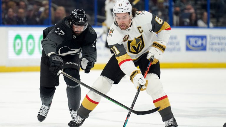 Vegas Golden Knights right wing Mark Stone (61) eludes Tampa Bay Lightning left wing Alex Killorn (17) during the first period of an NHL hockey game Saturday, Jan. 29, 2022, in Tampa, Fla. (Chris O'Meara/AP)