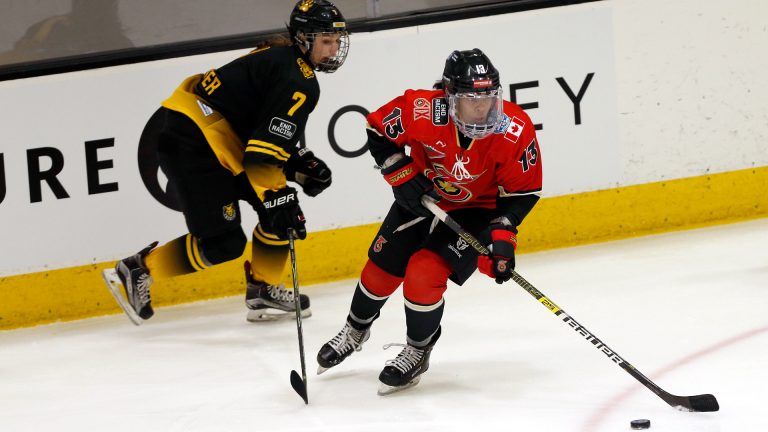 Toronto Six forward Mikyla Grant-Mentis (13) looks to pass the puck as Boston Pride forward Mary Parker (7) defends during the first period of a semifinal in the NWHL Isobel Cup hockey tournament Friday, March 26, 2021, in Boston. (Mary Schwalm/AP)