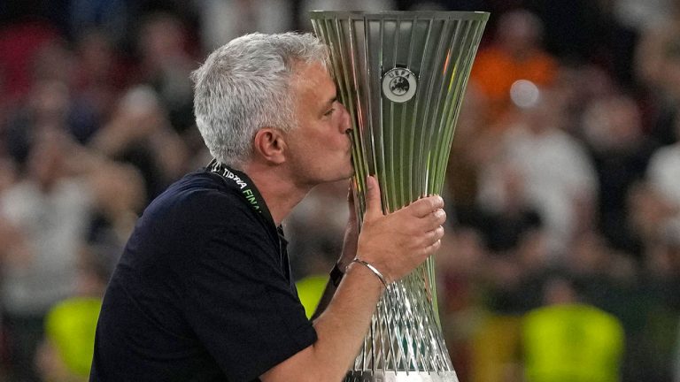 Roma's head coach Jose Mourinho, right, kisses the trophy at the end of the Europa Conference League final soccer match between AS Roma and Feyenoord at National Arena. (Thanassis Stavrakis/AP)