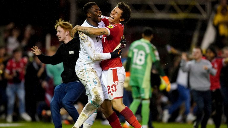 Nottingham Forest goalkeeper Brice Samba, left, and Brennan Johnson celebrate after defeating Sheffield United in a penalty kick shootout in a Sky Bet Championship play-off semi-final, second leg soccer match at the City Ground, Nottingham, England, Tuesday May 17, 2022. (Zac Goodwin/PA via AP)