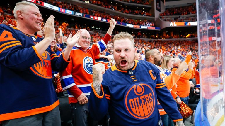 Edmonton Oilers fans celebrate their teams defat of the Calgary Flames following third period NHL second-round playoff hockey action in Edmonton, Tuesday, May 24, 2022. (Jeff McIntosh/THE CANADIAN PRESS)