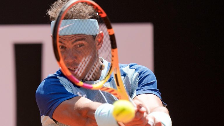 Rafael Nadal returns the ball to John Isner during their match at the Italian Open tennis tournament, in Rome, Wednesday, May 11, 2022. (Andrew Medichini/AP)