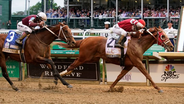 Rich Strike (21), with Sonny Leon aboard, beats Epicenter (3), with Joel Rosario aboard, at the finish line to win the 148th running of the Kentucky Derby horse race at Churchill Downs. (Mark Humphrey/AP)