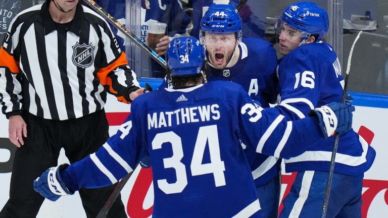 Toronto Maple Leafs defenceman Morgan Rielly (44) celebrates his goal with teammates Auston Matthews (34) and Mitchell Marner (16) while playing against the Tampa Bay Lightning during second period, first round, game seven NHL Stanley Cup playoff hockey action in Toronto on Saturday, May 14, 2022. (Nathan Denette/CP)