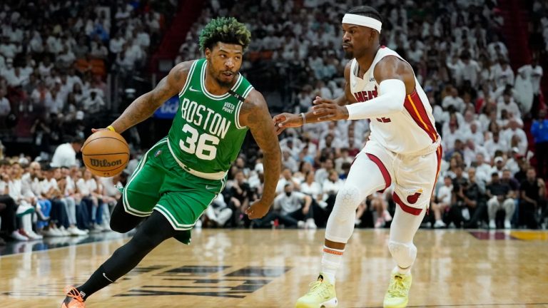 Boston Celtics guard Marcus Smart (36) dribbles around Miami Heat forward Jimmy Butler (22) during the first half of Game 2 of the NBA basketball Eastern Conference finals playoff series, Thursday, May 19, 2022, in Miami. (Lynne Sladky/AP)