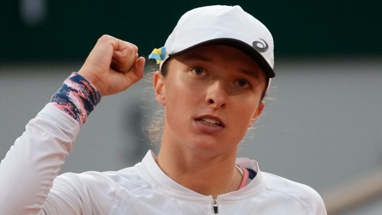 Poland's Iga Swiatek celebrates as she defeats China's Qinwen Zheng during their fourth round match of the French Open tennis tournament at the Roland Garros stadium Monday, May 30, 2022 in Paris. (Christophe Ena/AP)