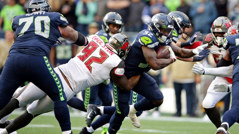 Seattle Seahawks running back Chris Carson (32) is tackled by Tampa Bay Buccaneers defensive tackle William Gholston (92) during the second half of an NFL football game, Sunday, Nov. 3, 2019, in Seattle. (Scott Eklund/AP)