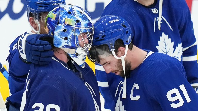 Toronto Maple Leafs forward John Tavares (91) hangs his head with Maple Leafs goaltender Jack Campbell (36) after being knocked out of the NHL Stanley Cup playoffs in game seven from the Tampa Bay Lightning in Toronto on Saturday, May 14, 2022. (Nathan Denette/CP)