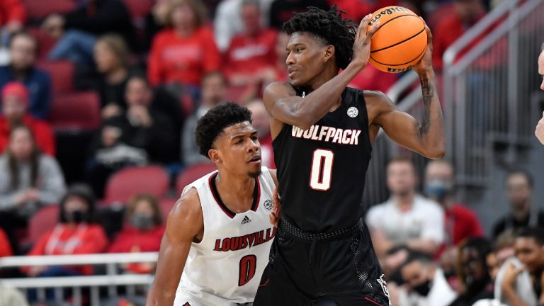 North Carolina State guard Terquavion Smith (0) keeps the ball away from Louisville guard Noah Locke (0) during the second half of an NCAA college basketball game in Louisville, Ky., Wednesday, Jan. 12, 2022. (Timothy D. Easley/AP)