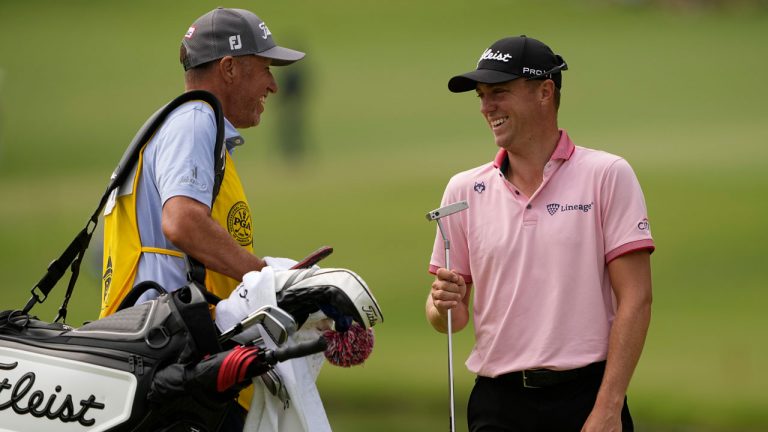 Justin Thomas celebrates after a birdie with his caddie on the 11th hole during the final round of the PGA Championship golf tournament at Southern Hills Country Club. (Matt York/AP)