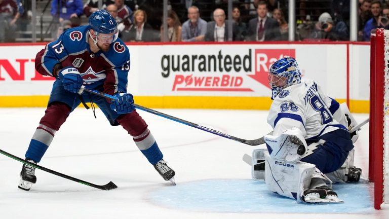 Tampa Bay Lightning goaltender Andrei Vasilevskiy (88) blocks a shot as Colorado Avalanche right wing Valeri Nichushkin (13) for a rebound during the second period in Game 2 of the NHL hockey Stanley Cup Final Saturday, June 18, 2022, in Denver. (John Locher/AP Photo)