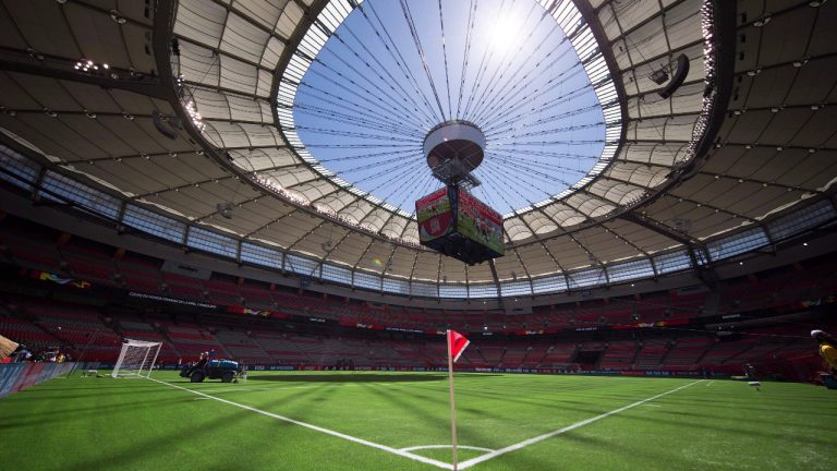 Water is sprayed on the artificial turf before Switzerland and Ecuador play a FIFA Women's World Cup soccer match at B.C. Place stadium in Vancouver, B.C., on June 12, 2015. (Darryl Dyck/CP)