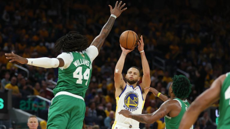 Golden State Warriors guard Stephen Curry (30) shoots against Boston Celtics center Robert Williams III (44) and guard Marcus Smart during the second half of Game 1 of basketball's NBA Finals in San Francisco, Thursday, June 2, 2022. (Jed Jacobsohn/AP)