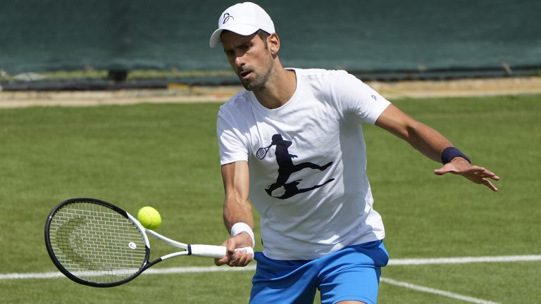 Serbia's Novak Djokovic plays a return as he practices ahead of the Wimbledon tennis championships in London, Sunday, June 26, 2022. (Alastair Grant/AP)