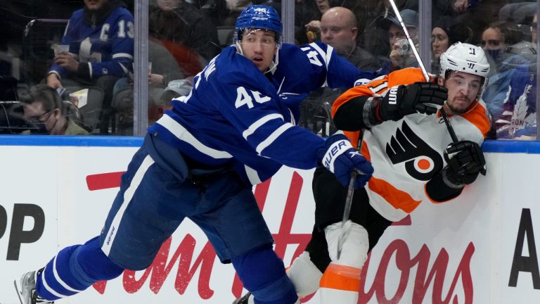 Toronto Maple Leafs defenceman Ilya Lyubushkin (46) drives Philadelphia Flyers forward Travis Konecny (11) into the boards during first period NHL hockey action in Toronto on Tuesday April 19, 2022 (Nathan Denette/CP)