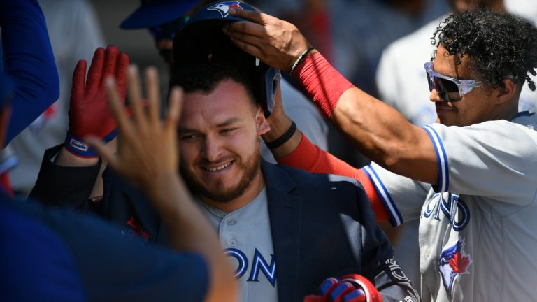 Toronto Blue Jays' Alejandro Kirk left, celebrates with teammate Santiago Espinal, right, along with other teammates in the dugout after hitting a solo home run during the third inning of a baseball game against the Chicago White Sox, Wednesday, June 22, 2022, in Chicago. (Paul Beaty/AP)