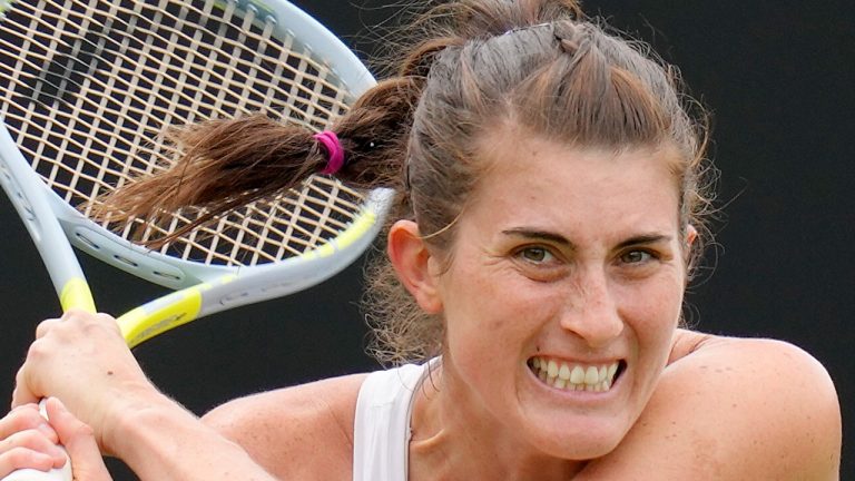 Rebecca Marino of Canada plays a return to Camila Giorgi of Italy during their singles tennis match at the Eastbourne International tennis tournament in Eastbourne, England, Tuesday, June 21, 2022. (Kirsty Wigglesworth/AP Photo)