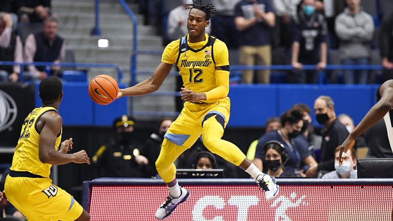 Marquette forward Olivier-Maxence Prosper (12) keep the ball from going out of bounds during an NCAA game against Connecticut. (Jessica Hill/AP)