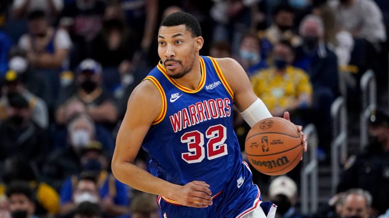 Golden State Warriors forward Otto Porter Jr. (32) dribbles the ball up the court against the Brooklyn Nets during the second half of an NBA basketball game. (Jeff Chiu/AP)