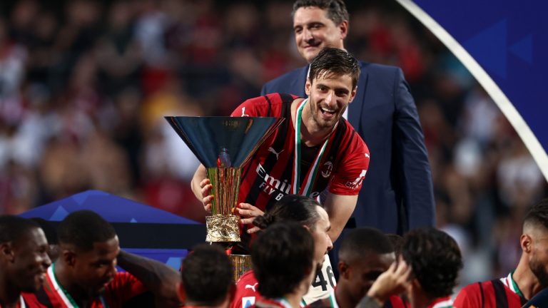 Matteo Gabbia (AC Milan) celebrates with the trophy after winning the Serie A championship title during US Sassuolo vs AC Milan, italian soccer Serie A match in Reggio Emilia, Italy, May 22 2022