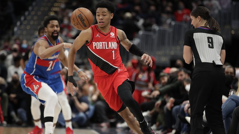 Portland Trail Blazers' Anfernee Simons (1) reaches for the ball out of bounds as Washington Wizards' Spencer Dinwiddie, left, defends during the second half of an NBA basketball game. (Luis M. Alvarez/AP)