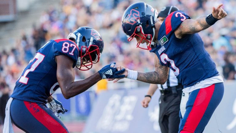 Montreal Alouettes quarterback Vernon Adams Jr. (3) celebrates with teammate Eugene Lewis after scoring a touchdown during first half CFL pre-season football action against the Ottawa Redblacks in Montreal, Friday, June, 3, 2022. (Graham Hughes/CP)