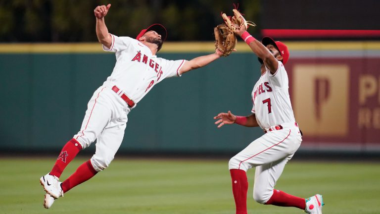 Los Angeles Angels second baseman Jack Mayfield (9) and right fielder Jo Adell (7) collide while reaching to catch a fly ball hit by Boston Red Sox's Xander Bogaerts during the seventh inning of a baseball game in Anaheim, Calif., Wednesday, June 8, 2022. Adell caught the ball. (Ashley Landis/AP)