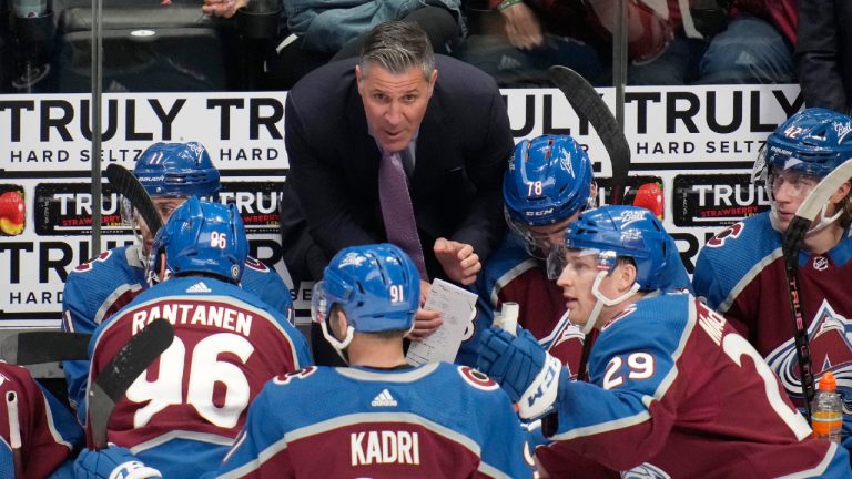 Colorado Avalanche coach Jared Bednar confers with players during the third period of the team's NHL hockey game against the Vancouver Canucks on Wednesday, March 23, 2022, in Denver. (David Zalubowski/AP) 