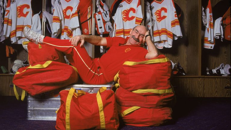 Canadian Bearcat Murray, trainer of the Calgary Flames hockey team, reclines on top of the team's equipment bags and trainer's chest in the locker room. (Bruce Bennett Studios/Getty Images)
