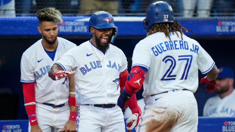 Toronto Blue Jays first baseman Vladimir Guerrero Jr. (27) celebrates his solo home run against the Baltimore Orioles with teammates Teoscar Hernandez (37) and Lourdes Gurriel Jr. (13) during fifth inning American League, MLB baseball action in Toronto on Wednesday, June 15, 2022. (Nathan Denette/CP)