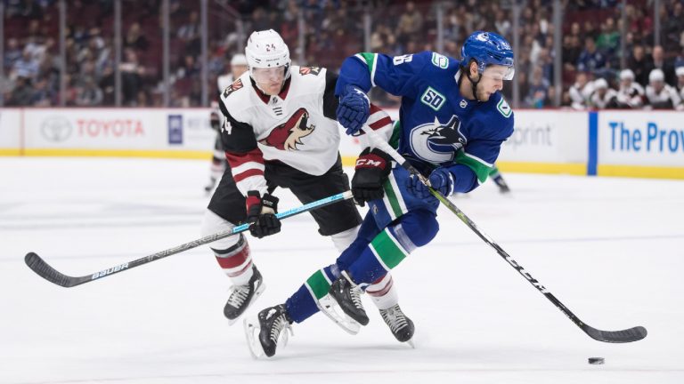 Arizona Coyotes right wing Hudson Fasching, left, and Vancouver Canucks defenceman Guillaume Brisebois collide during the first period of a pre-season NHL hockey game in Vancouver, on Thursday September 26, 2019. (Darryl Dyck/CP)