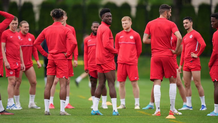 Canadian national men's soccer team forward Alphonso Davies, centre, stands with his teammates during a training session for a CONCACAF Nations League match against Curacao, in Vancouver. (Darryl Dyck/CP)